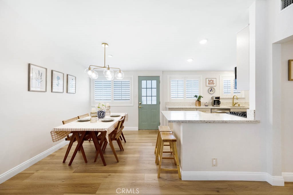 954 Delay Avenue Glendora, CA 91740 - Photo 8 of 35 a dining room with wooden floor a chandelier a wooden table and chairs