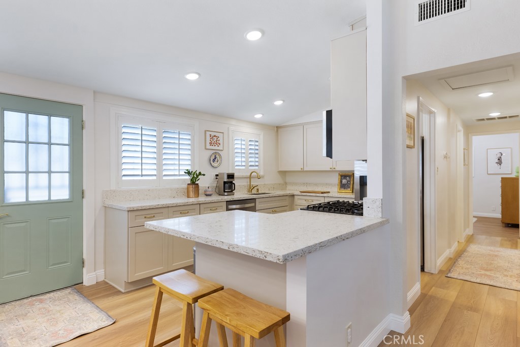 954 Delay Avenue Glendora, CA 91740 - Photo 10 of 35 a kitchen with center island and stainless steel appliances