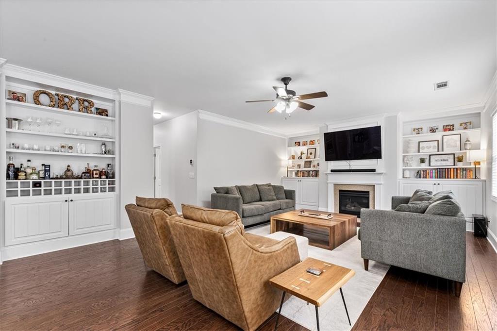 556 Olympic Way Acworth, GA 30102 - Photo 14 of 41 a living room with furniture a fireplace and a flat screen tv