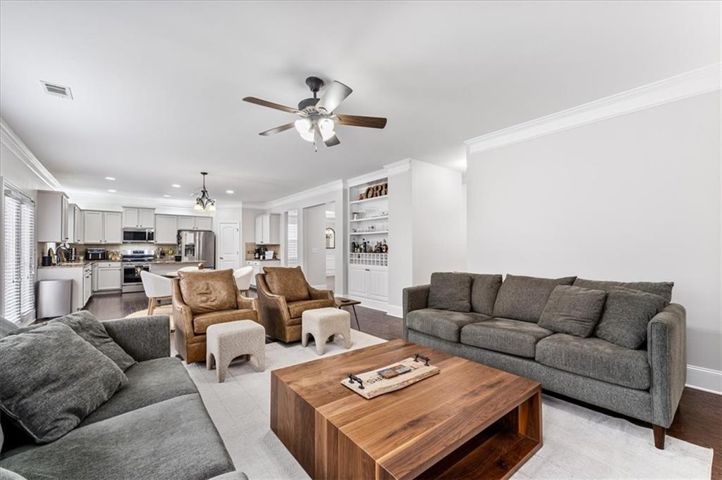 556 Olympic Way Acworth, GA 30102 - Photo 15 of 41 a living room with furniture a rug and a chandelier
