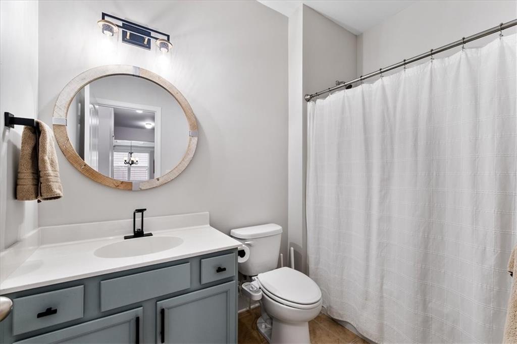 556 Olympic Way Acworth, GA 30102 - Photo 16 of 41 a bathroom with a sink a toilet and a mirror
