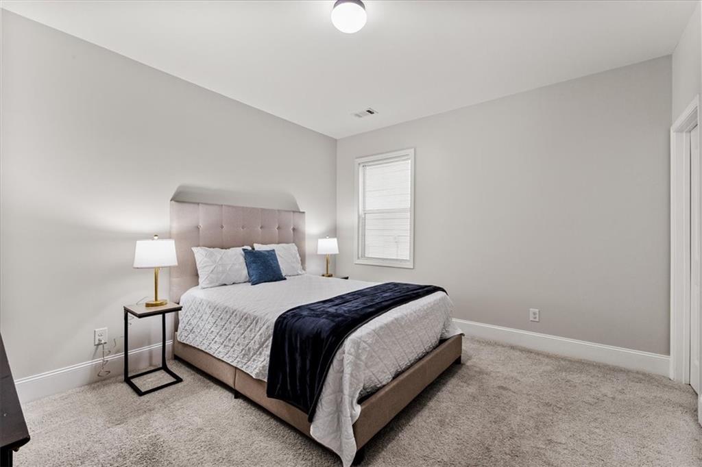 556 Olympic Way Acworth, GA 30102 - Photo 17 of 41 a bedroom with a bed and a lamp