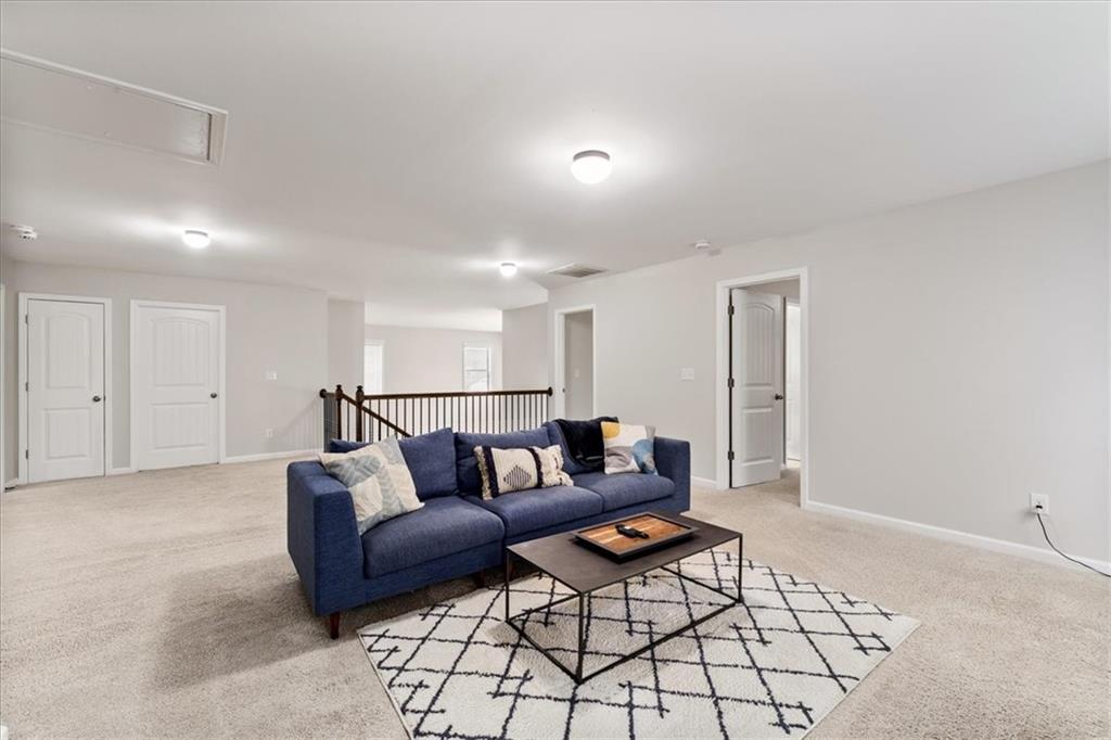 556 Olympic Way Acworth, GA 30102 - Photo 19 of 41 a living room with furniture and a rug