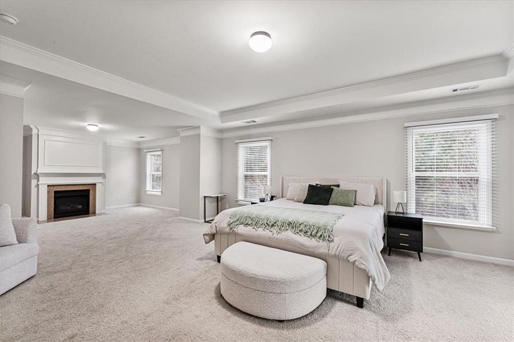 556 Olympic Way Acworth, GA 30102 - Photo 20 of 41 a spacious bedroom with a bed and a fireplace