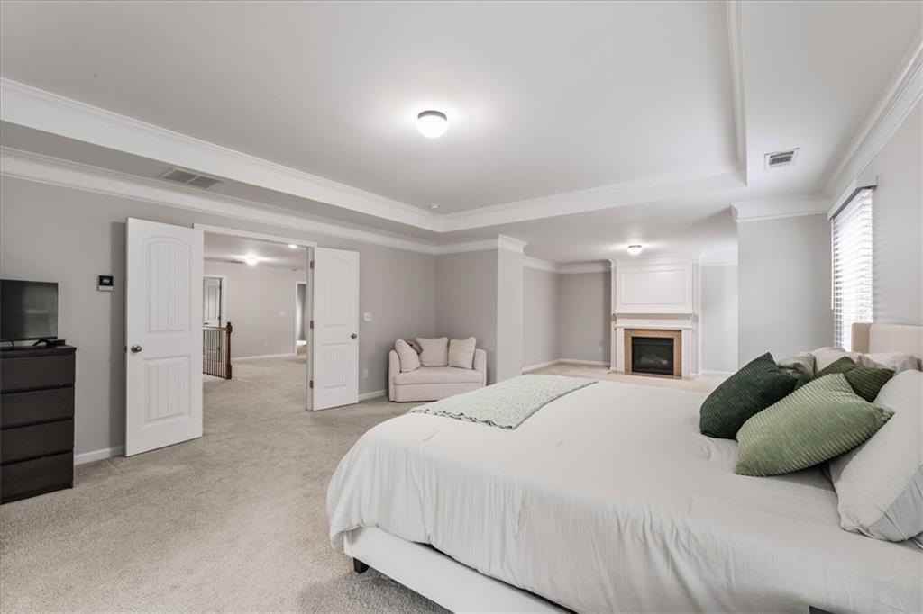 556 Olympic Way Acworth, GA 30102 - Photo 21 of 41 a bedroom with a bed and ceiling fan