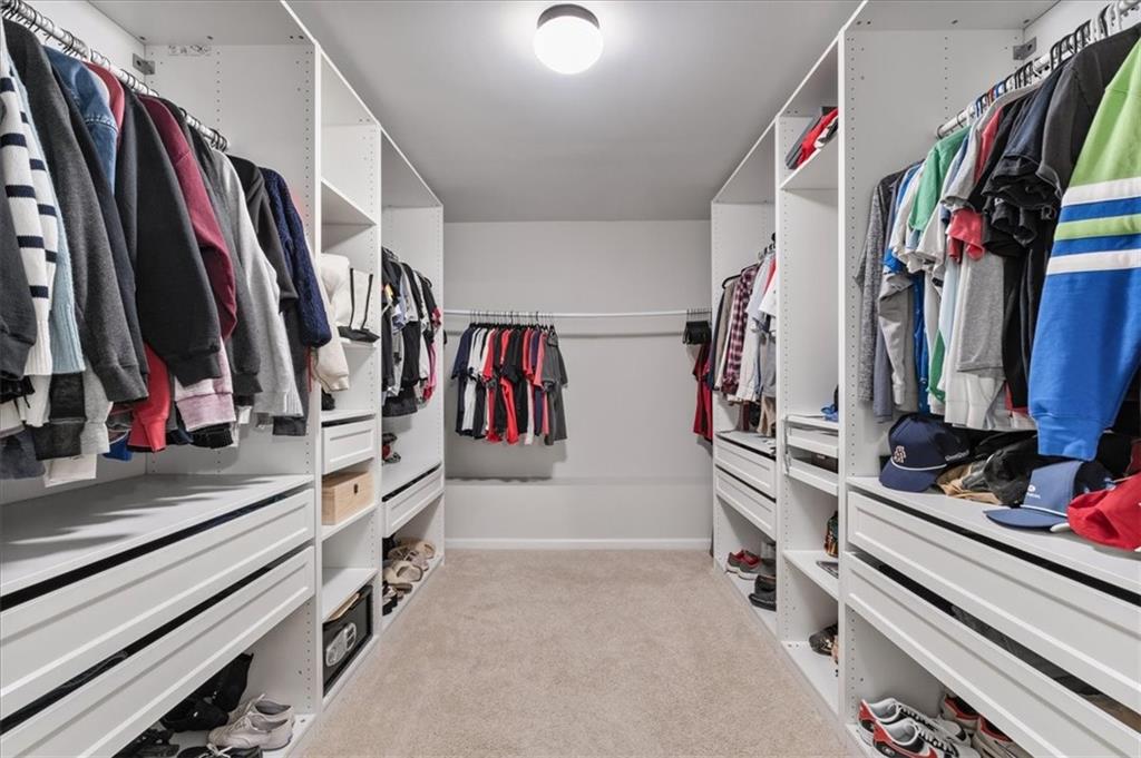 556 Olympic Way Acworth, GA 30102 - Photo 25 of 41 a view of walk in closet with clothes and shoes
