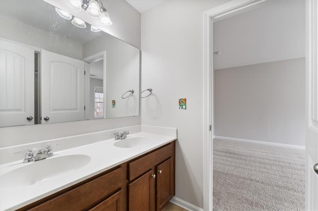 556 Olympic Way Acworth, GA 30102 - Photo 29 of 41 a bathroom with a sink a vanity a mirror and shower