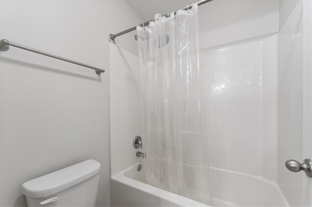 556 Olympic Way Acworth, GA 30102 - Photo 30 of 41 a bathroom with a shower curtain and toilet
