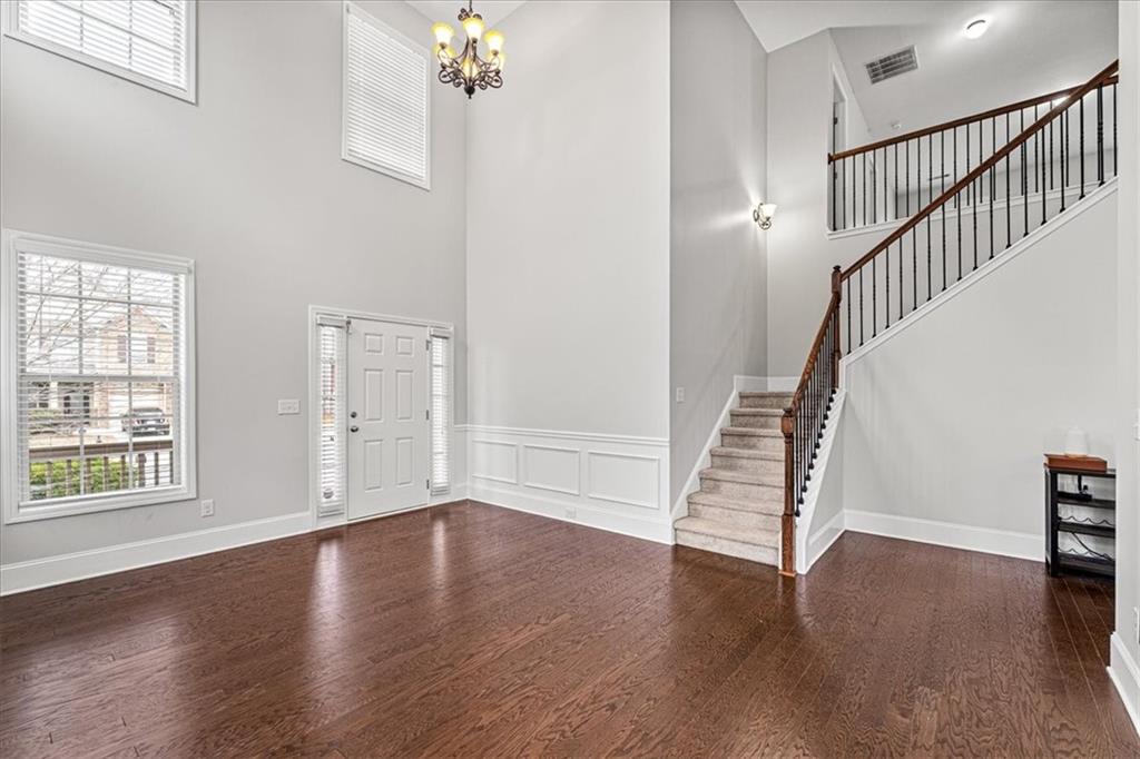556 Olympic Way Acworth, GA 30102 - Photo 3 of 41 a view of an empty room with wooden floor and stairs