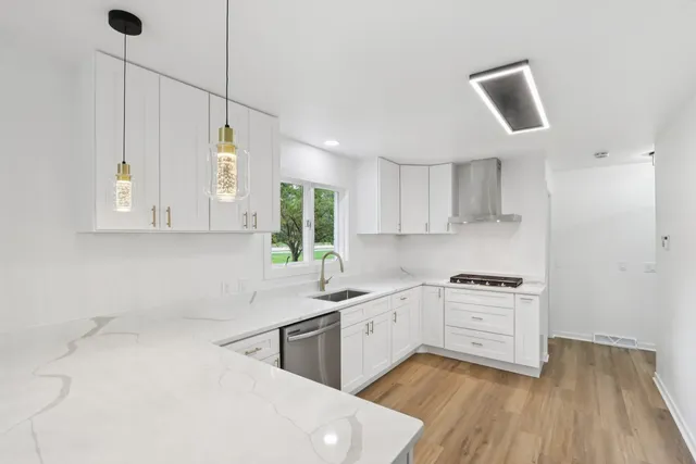 a kitchen with a sink window and cabinets