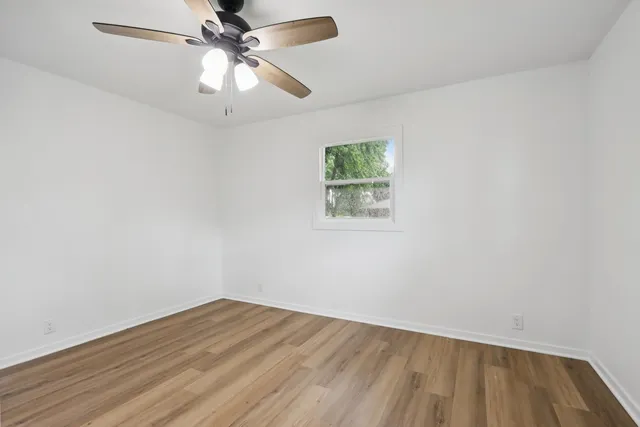 a view of room with window and ceiling fan