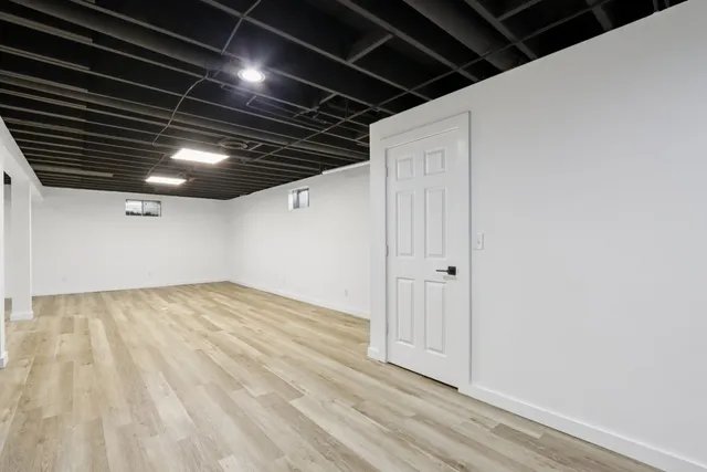 a front view of house with yard and trees in the background