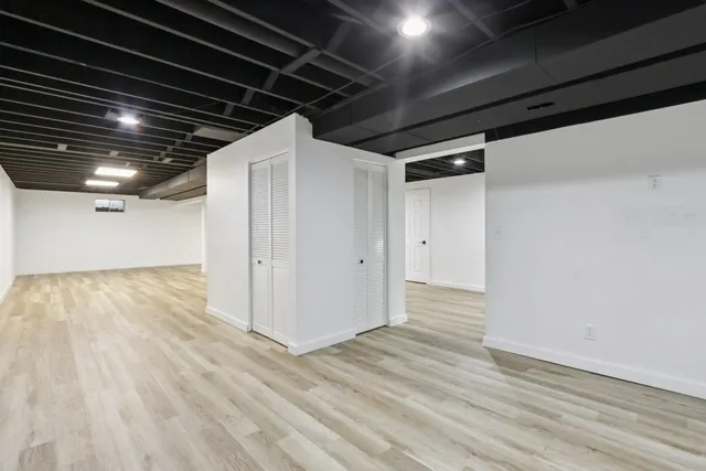 a view of a house with a yard deck and a large tree