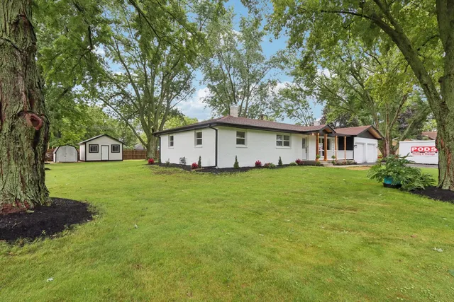 a front view of house with yard and green space