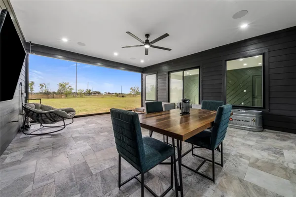 a living room with furniture floor to ceiling window and floor to ceiling window