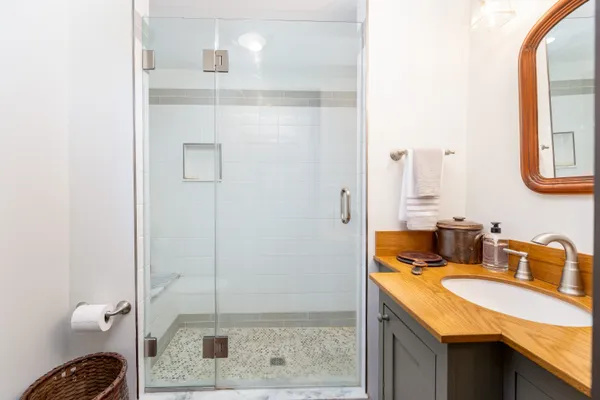 a bathroom with a granite countertop sink and a mirror