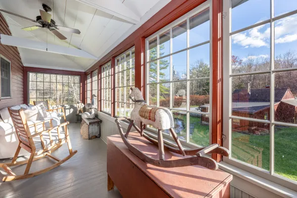 a view of a living room with furniture and floor to ceiling windows
