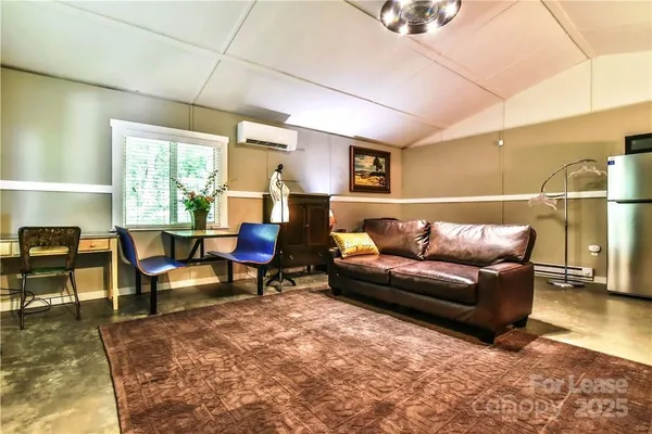 a living room with furniture window and wooden floor