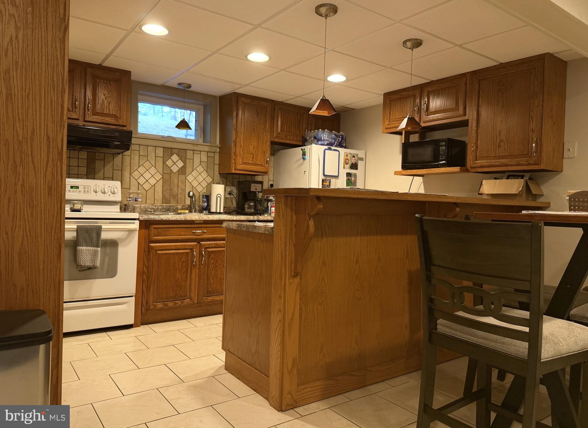 17 Mountain View Trail Fairfield, PA 17320 - Photo 20 of 23 a kitchen with kitchen island granite countertop wooden cabinets and white appliances