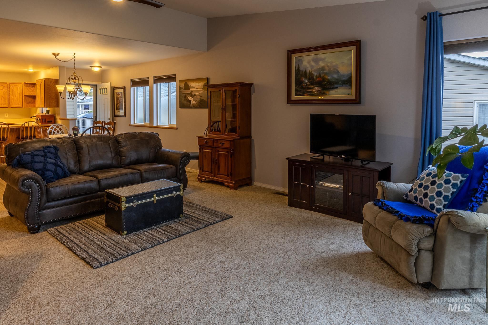 925 Hawthorne Street, Unit A Lewiston, ID 83501 - Photo 11 of 25 Living area with a chandelier and light carpet