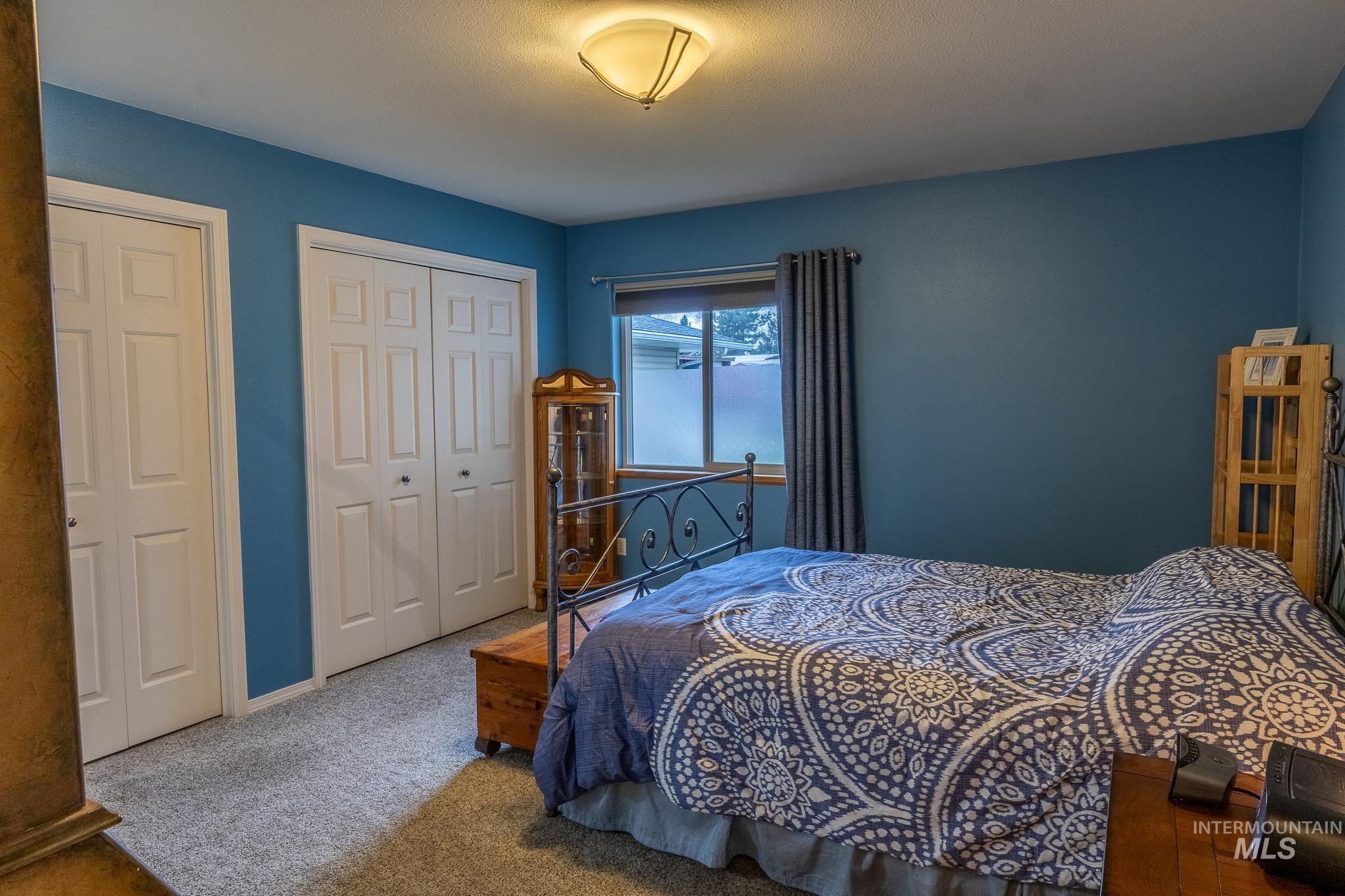 925 Hawthorne Street, Unit A Lewiston, ID 83501 - Photo 13 of 25 Bedroom with carpet floors and multiple closets