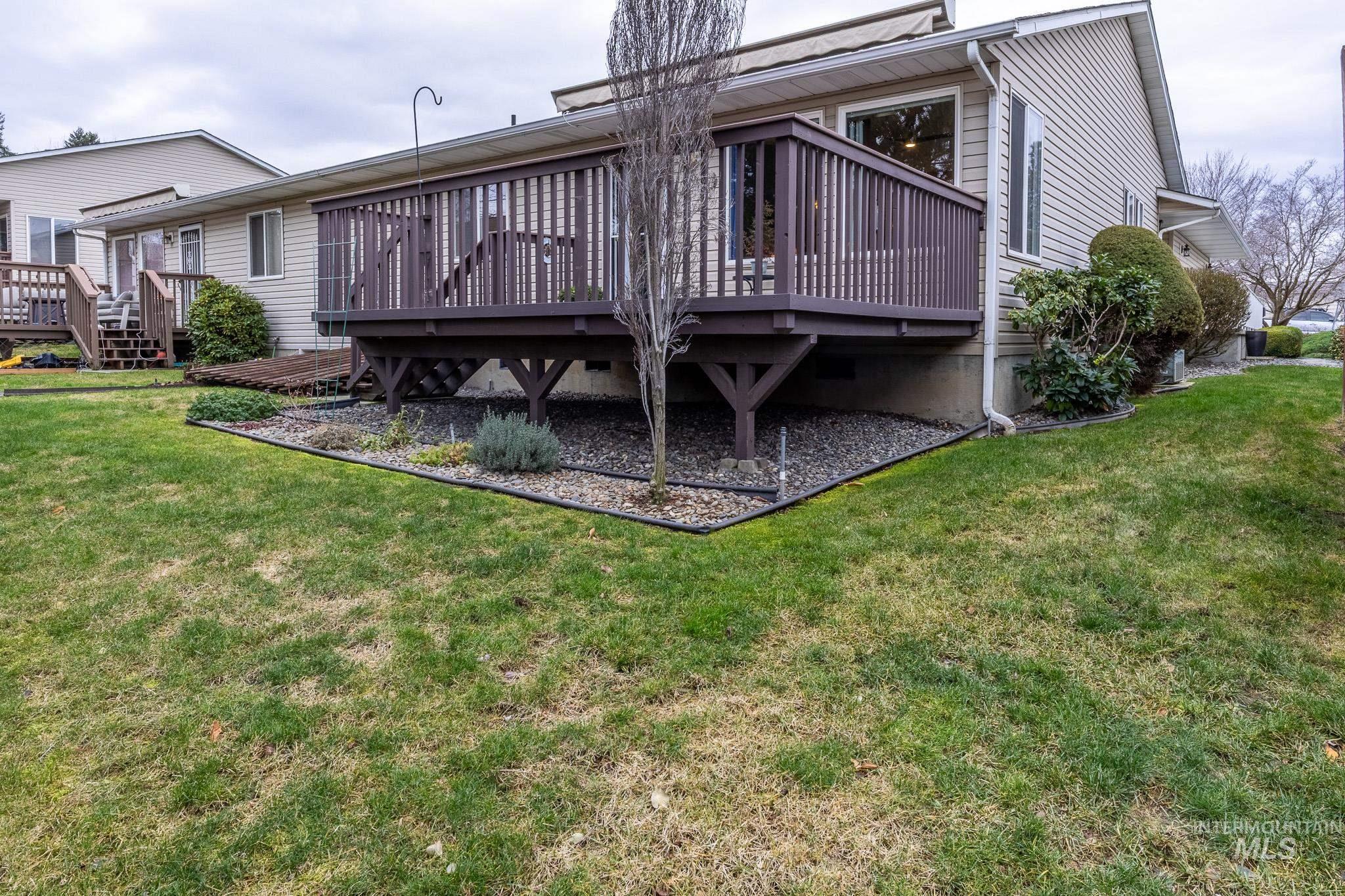 925 Hawthorne Street, Unit A Lewiston, ID 83501 - Photo 24 of 25 Back of property with a wooden deck and a lawn