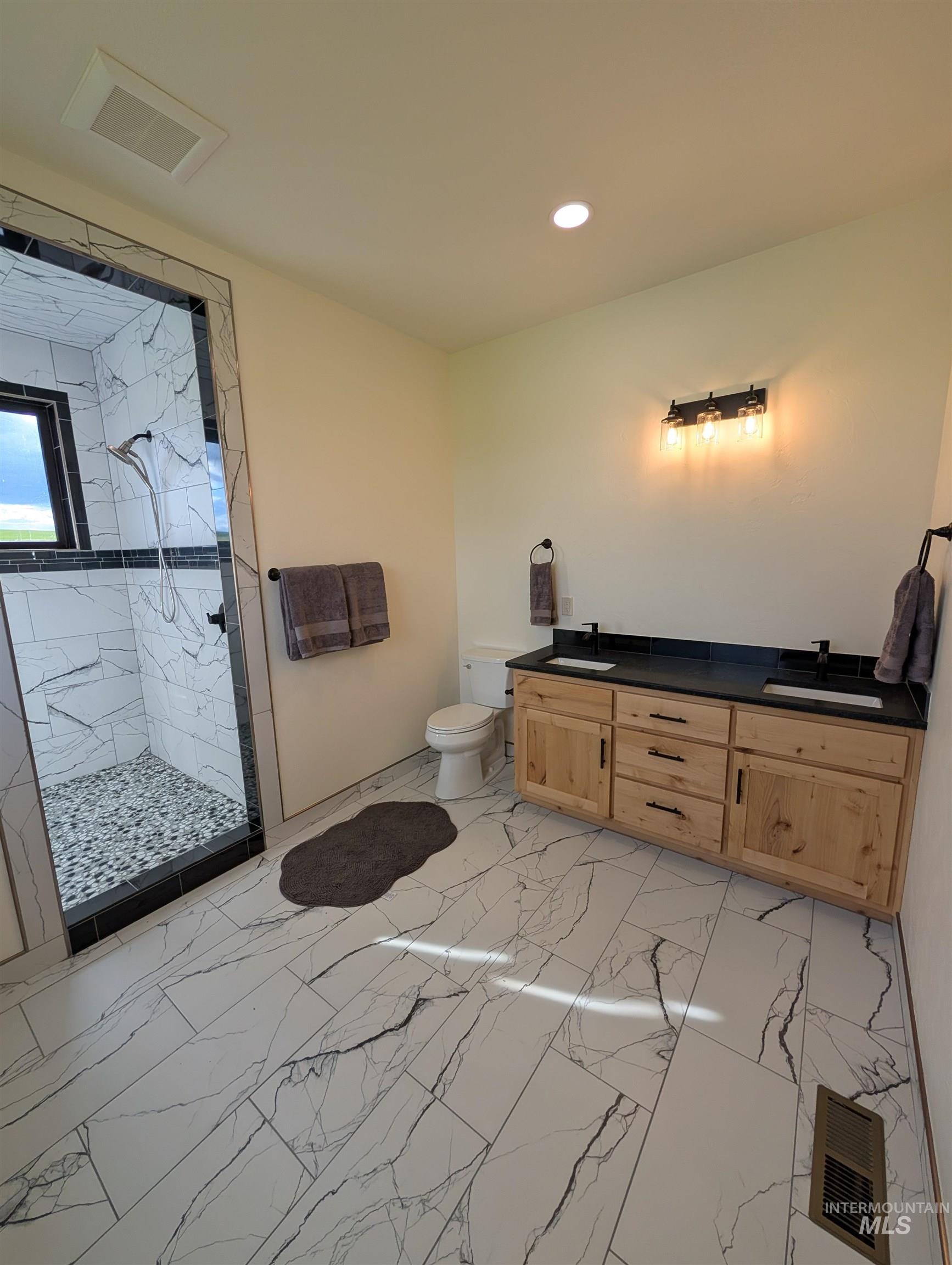 137 Angus Ranch Grangeville, ID 83530 - Photo 16 of 49 Bathroom featuring a marble finish shower, light marble finish floors, double vanity, and recessed lighting