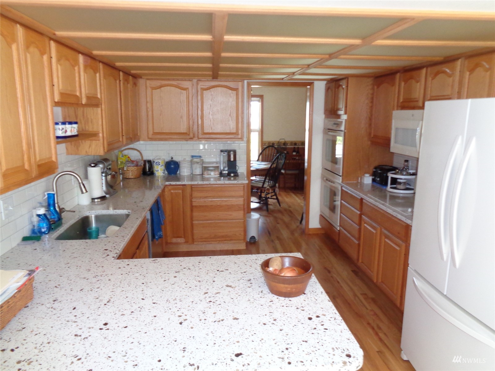 9517 185th Avenue Southwest Rochester, WA 98579 - Photo 15 of 28 a kitchen with stainless steel appliances a sink a refrigerator a stove and white cabinets