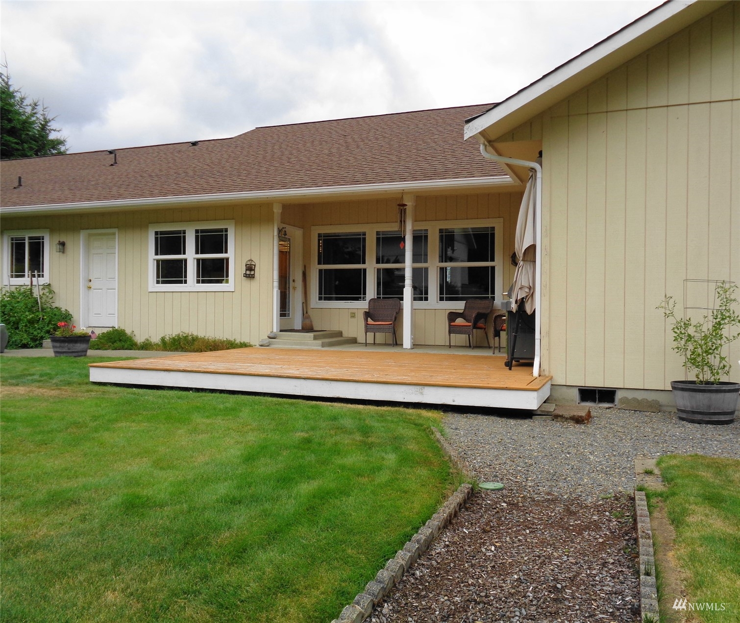 9517 185th Avenue Southwest Rochester, WA 98579 - Photo 4 of 28 a view of a house with a garden and porch