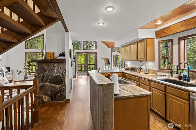 a kitchen with sink cabinets and wooden floor