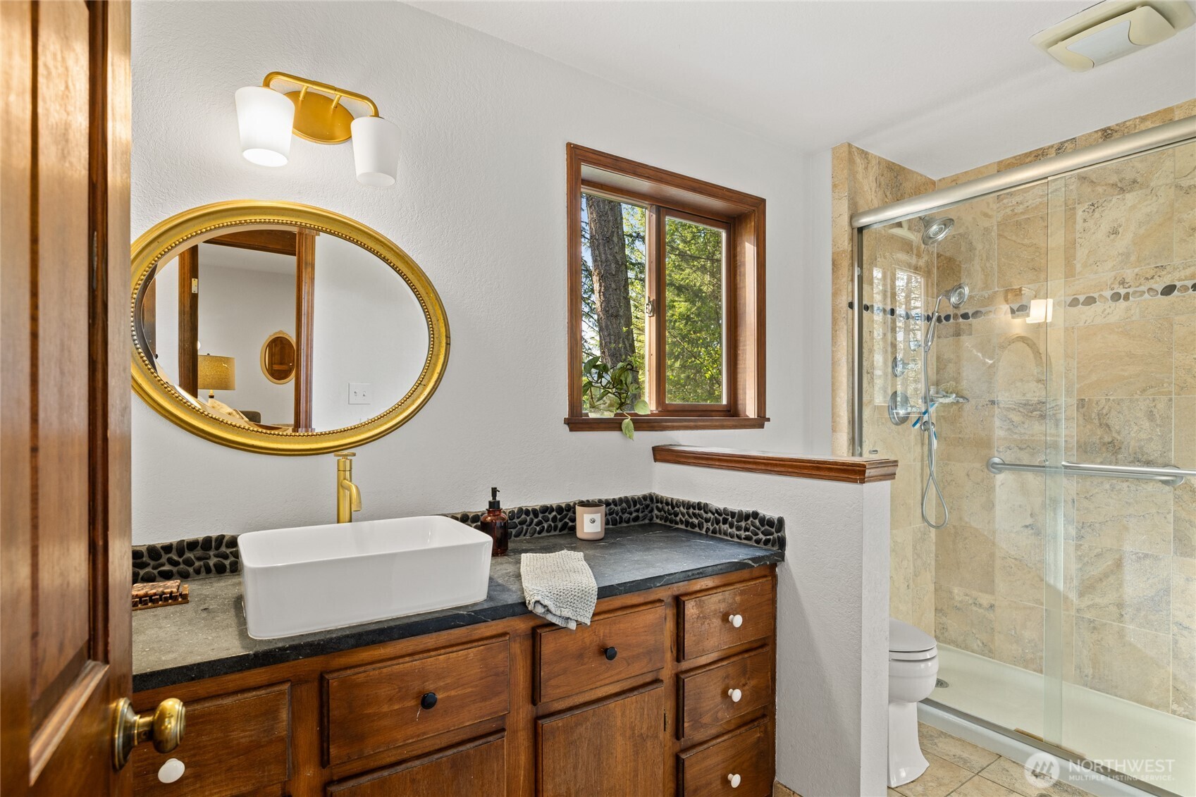 4265 Highway 97 Peshastin, WA 98847 - Photo 22 of 38 a bathroom with a sink a mirror and a shower