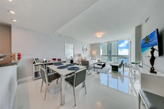 a view of a dining room with furniture and a kitchen