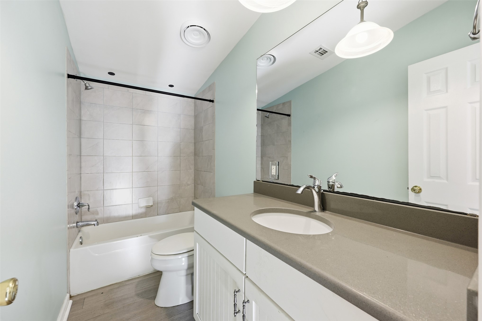 85232 Burmeister Road Fernandina Beach, FL 32034 - Photo 18 of 32 a bathroom with a granite countertop sink toilet a mirror and shower