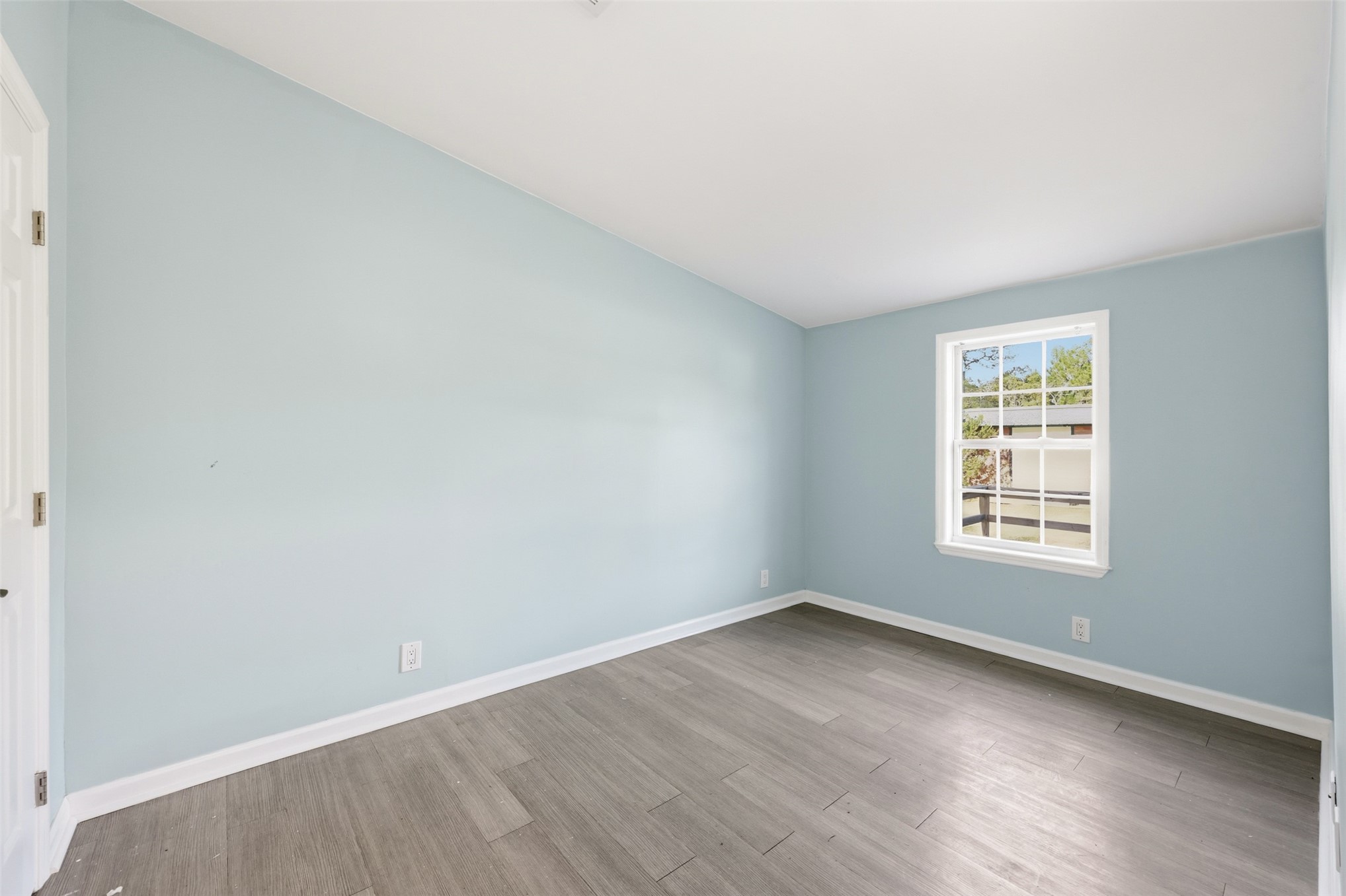 85232 Burmeister Road Fernandina Beach, FL 32034 - Photo 19 of 32 an empty room with wooden floor and window