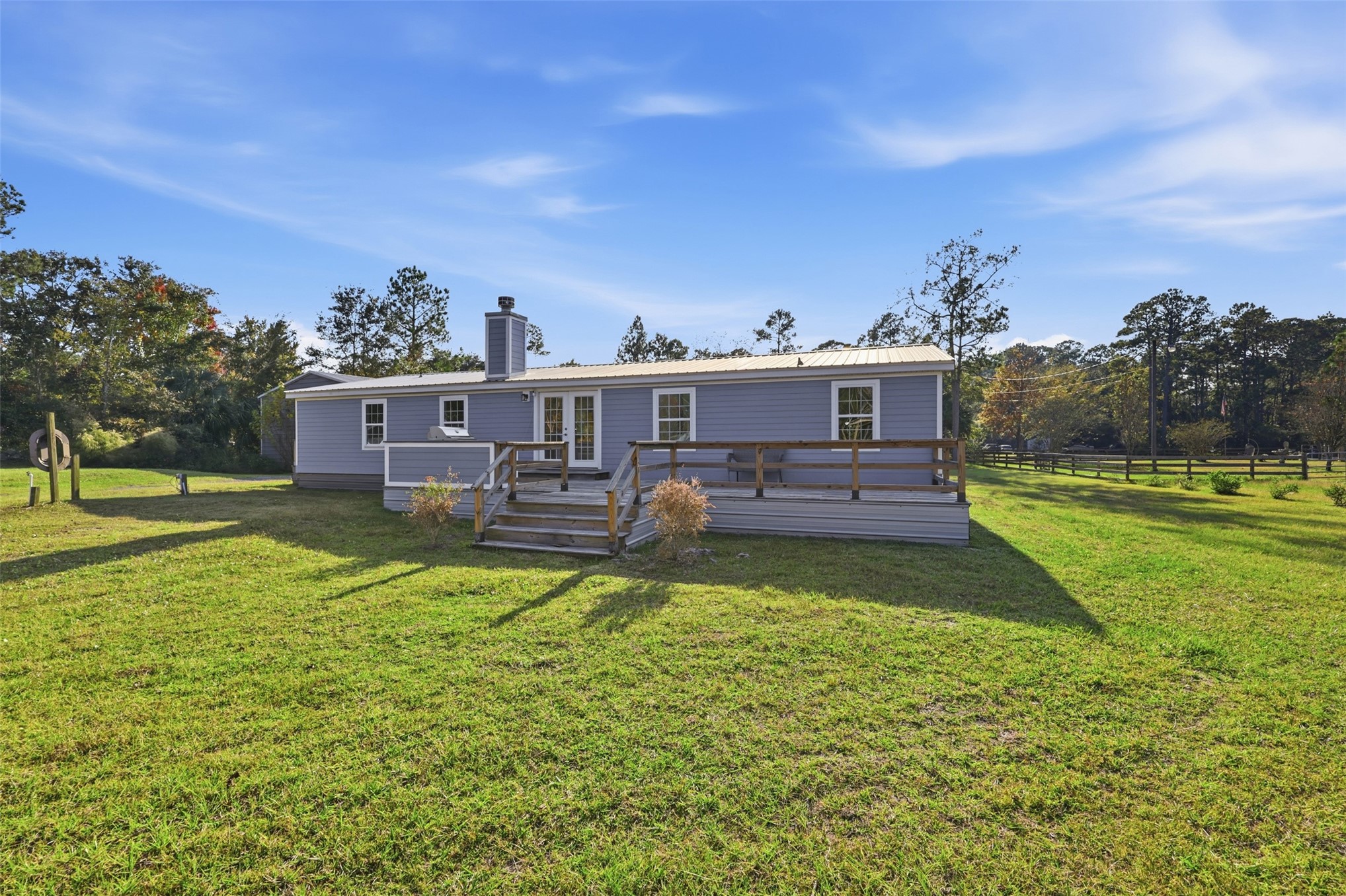 85232 Burmeister Road Fernandina Beach, FL 32034 - Photo 25 of 32 a view of a house with a big yard potted plants and large tree