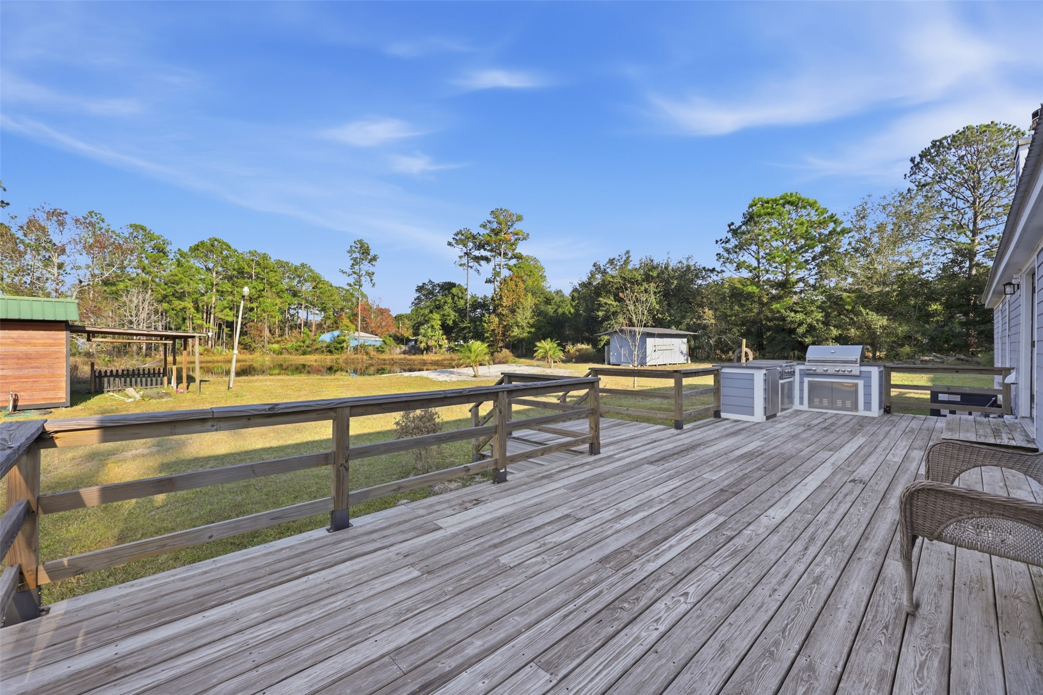 85232 Burmeister Road Fernandina Beach, FL 32034 - Photo 26 of 32 a roof deck with table and chairs a barbeque with wooden floor and city view