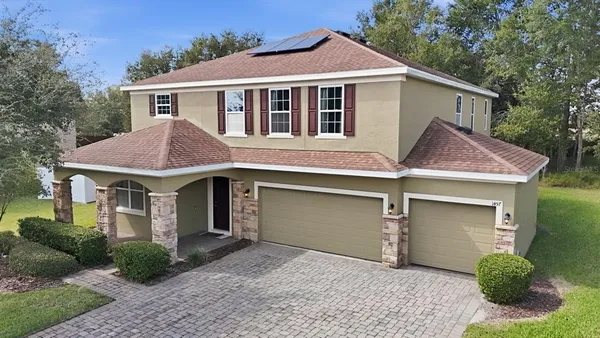 a front view of a house with a yard and garage
