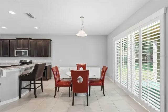 a dining room with furniture and window