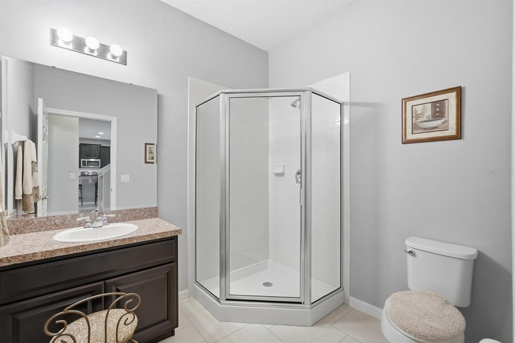 1457 Osprey Ridge Drive Eustis, FL 32736 - Photo 19 of 54 a bathroom with a sink a toilet and shower