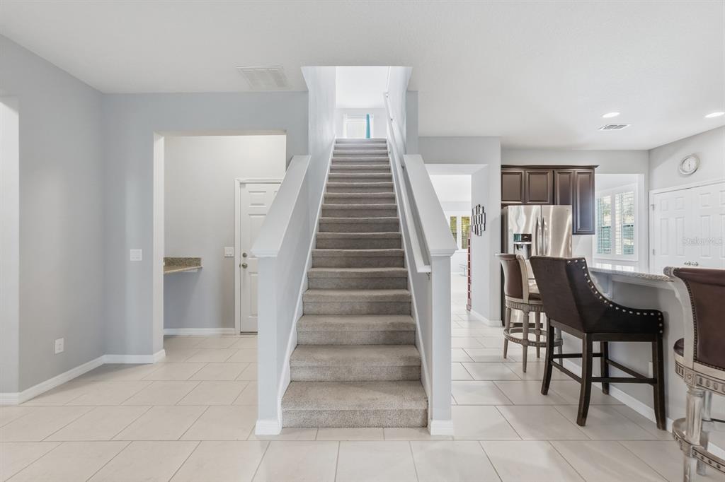 1457 Osprey Ridge Drive Eustis, FL 32736 - Photo 21 of 54 a view of a livingroom with furniture and stairs