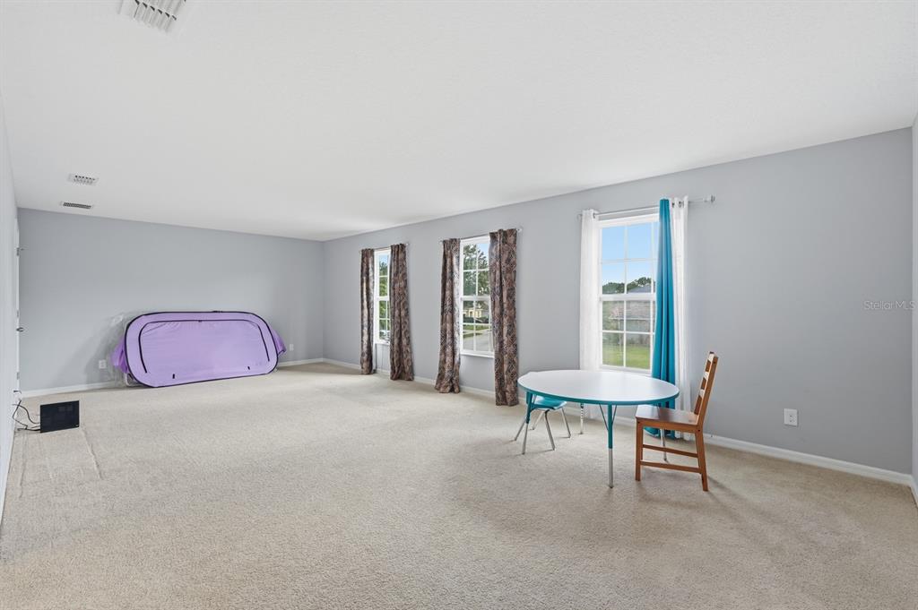 1457 Osprey Ridge Drive Eustis, FL 32736 - Photo 25 of 54 a bedroom with furniture and a window