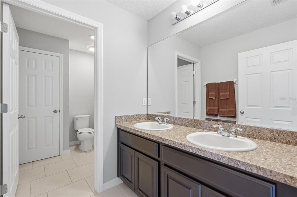 1457 Osprey Ridge Drive Eustis, FL 32736 - Photo 28 of 54 a bathroom with a granite countertop sink and a mirror
