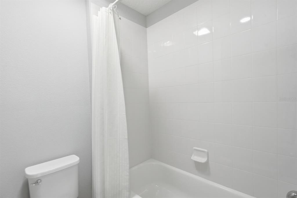 1457 Osprey Ridge Drive Eustis, FL 32736 - Photo 29 of 54 a bathroom with a white toilet and sink