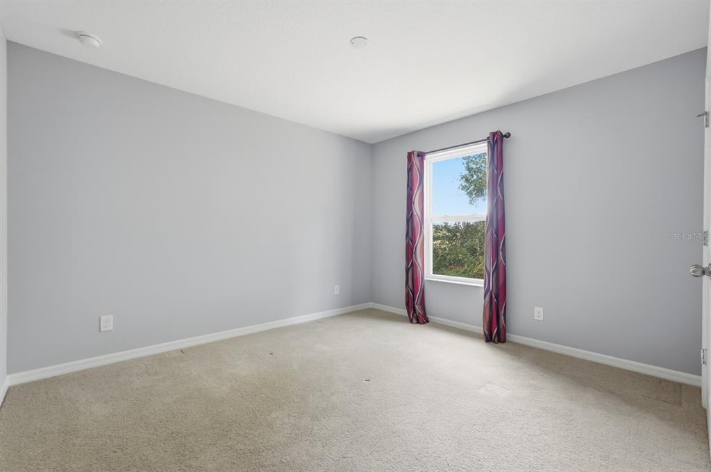 1457 Osprey Ridge Drive Eustis, FL 32736 - Photo 31 of 54 a view of an empty room with a window