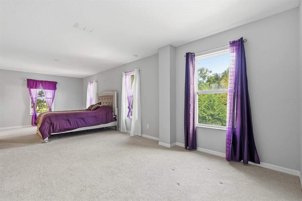 1457 Osprey Ridge Drive Eustis, FL 32736 - Photo 33 of 54 a spacious bedroom with a bed and a window