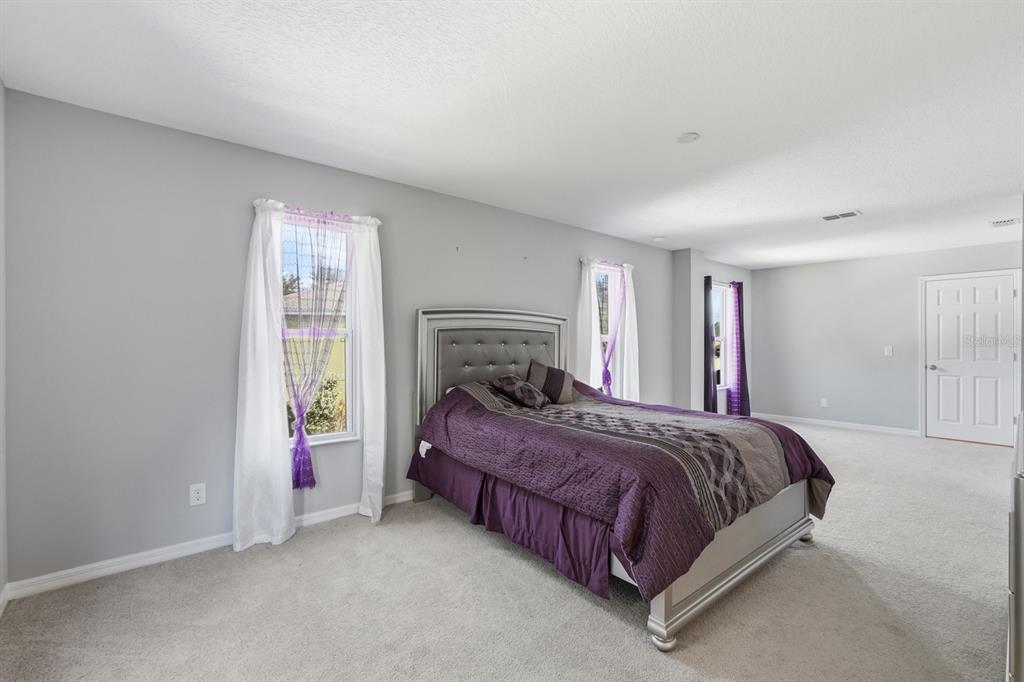 1457 Osprey Ridge Drive Eustis, FL 32736 - Photo 34 of 54 a bedroom with a bed and a window