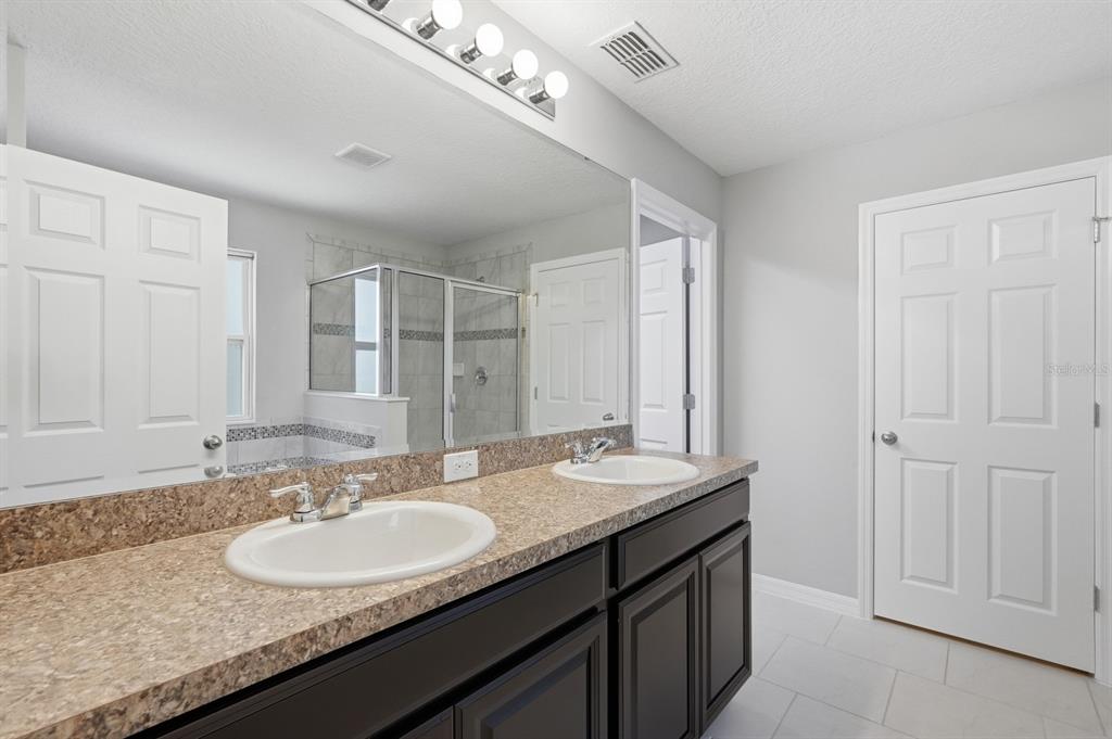 1457 Osprey Ridge Drive Eustis, FL 32736 - Photo 38 of 54 a bathroom with double sink and a mirror
