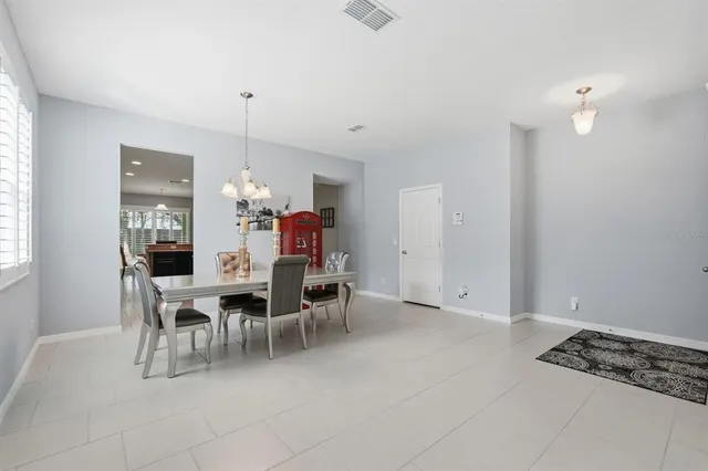a view of a dining room with furniture and chandelier