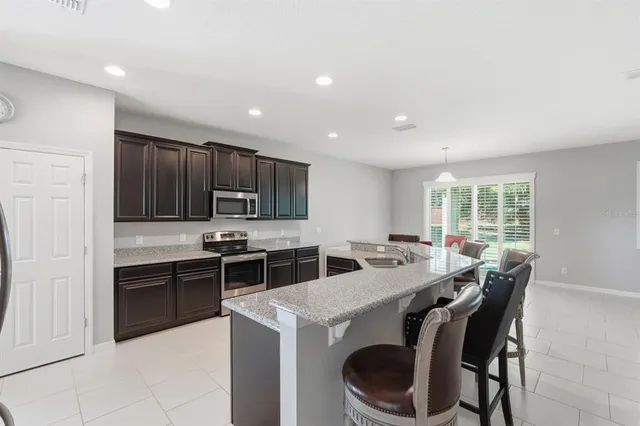 a kitchen with a stove a sink and a refrigerator