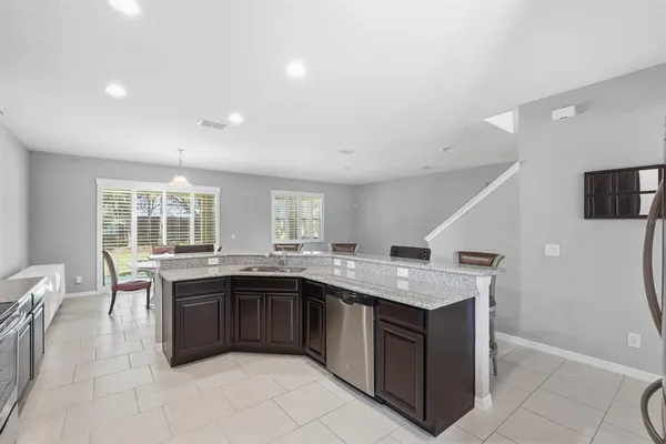a kitchen with a stove sink and cabinets